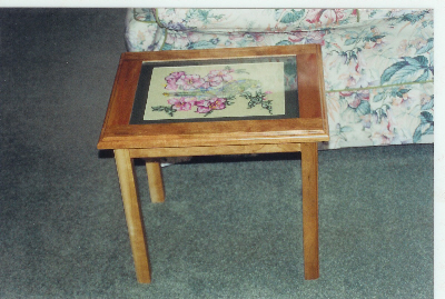 Side table with glass covered tapistry